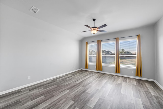 unfurnished room featuring vaulted ceiling, ceiling fan, and hardwood / wood-style flooring