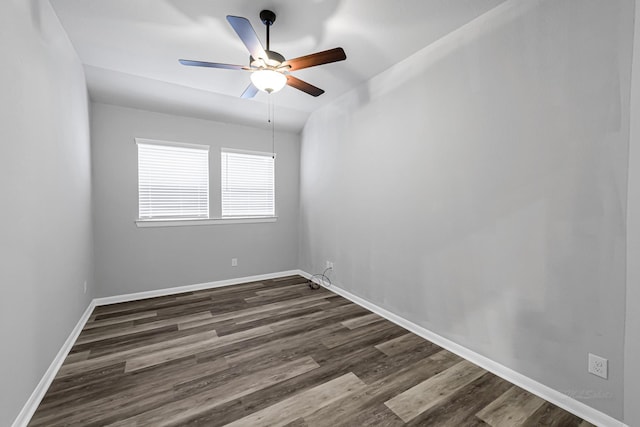 spare room with ceiling fan, dark hardwood / wood-style floors, and vaulted ceiling