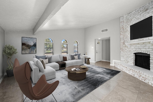 living room featuring beam ceiling and a fireplace