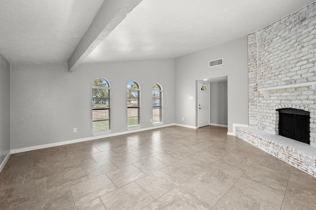 unfurnished living room with beam ceiling and a fireplace