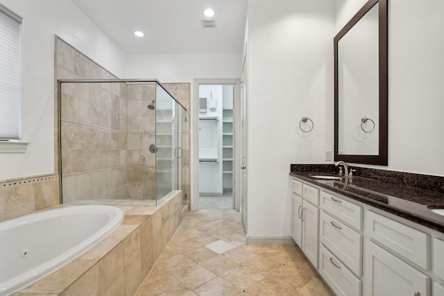 bathroom featuring vanity and shower with separate bathtub