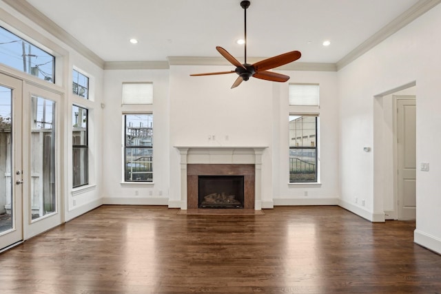 unfurnished living room featuring dark wood-type flooring, ceiling fan, and ornamental molding