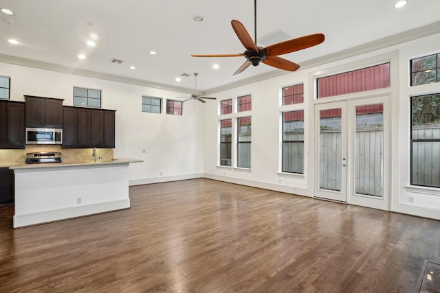 unfurnished living room featuring ceiling fan, dark hardwood / wood-style flooring, and ornamental molding