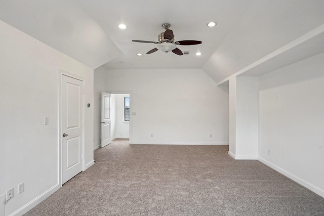 carpeted empty room featuring ceiling fan and lofted ceiling