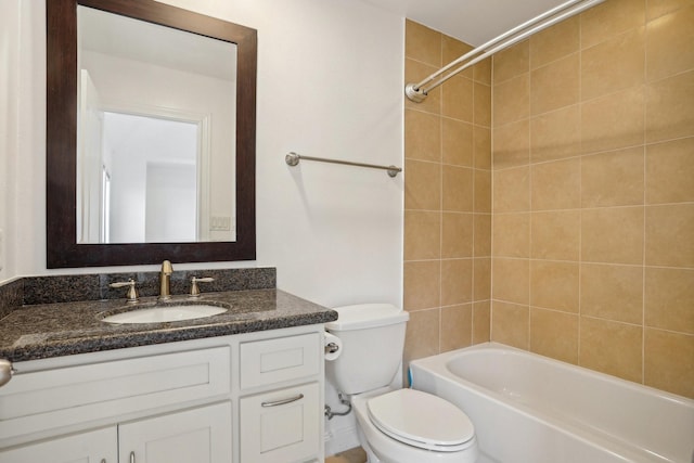 full bathroom with toilet, vanity, and tiled shower / bath combo