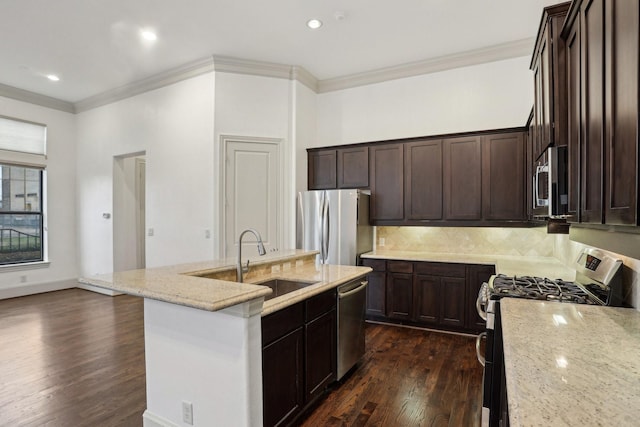 kitchen featuring dark wood-type flooring, light stone countertops, stainless steel appliances, and a kitchen island with sink