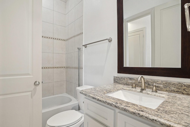 full bathroom featuring toilet, tiled shower / bath combo, and vanity