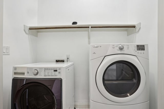 clothes washing area with washing machine and clothes dryer