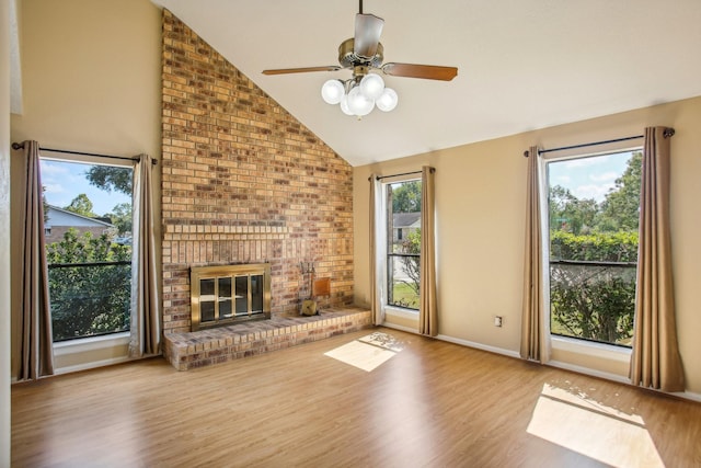 unfurnished living room featuring vaulted ceiling, light hardwood / wood-style floors, and a fireplace