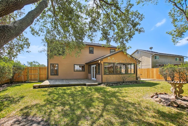 back of house with a wooden deck and a lawn