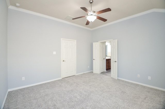 carpeted spare room with ceiling fan and crown molding