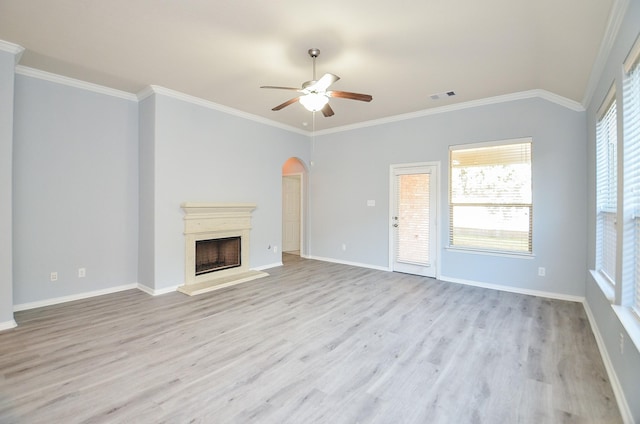 unfurnished living room featuring ceiling fan, crown molding, and light wood-type flooring