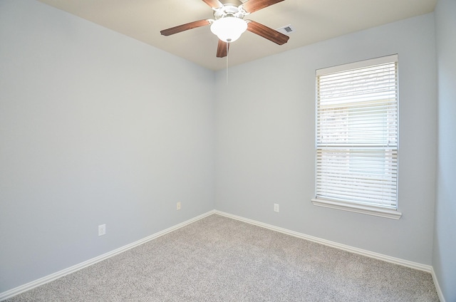 carpeted spare room with ceiling fan