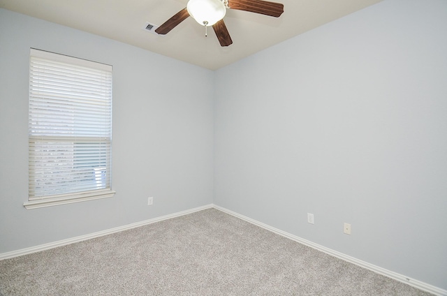 carpeted spare room with ceiling fan