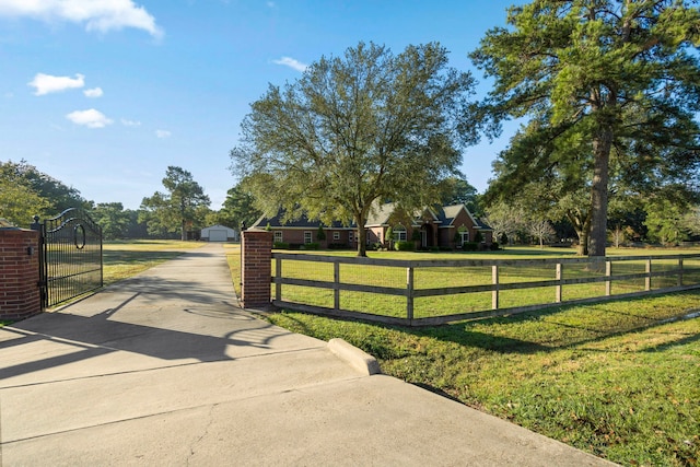 view of gate with a yard