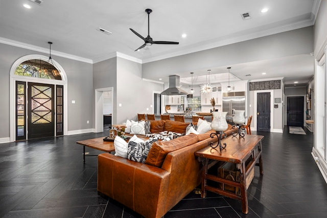 living room featuring ceiling fan, crown molding, and dark parquet floors