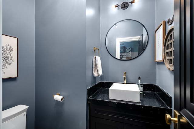 bathroom with toilet and vanity