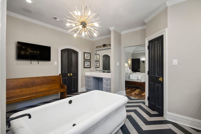 bathroom featuring a chandelier, a bathtub, vanity, and ornamental molding