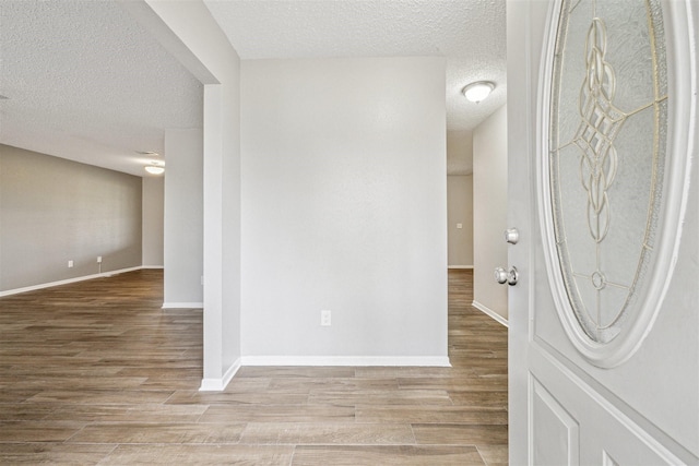 foyer featuring a textured ceiling and hardwood / wood-style floors