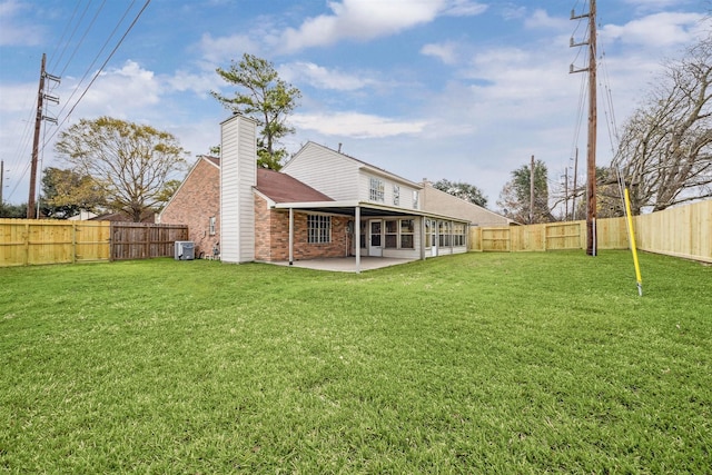 rear view of property featuring a patio area and a yard