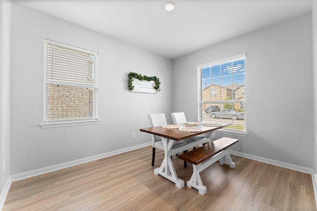 dining space with light hardwood / wood-style flooring