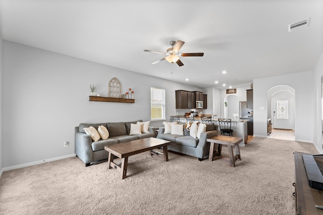 living room with ceiling fan and light carpet