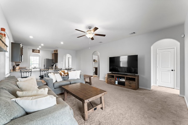 living room with ceiling fan and light carpet