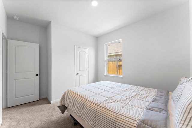 bedroom featuring light colored carpet