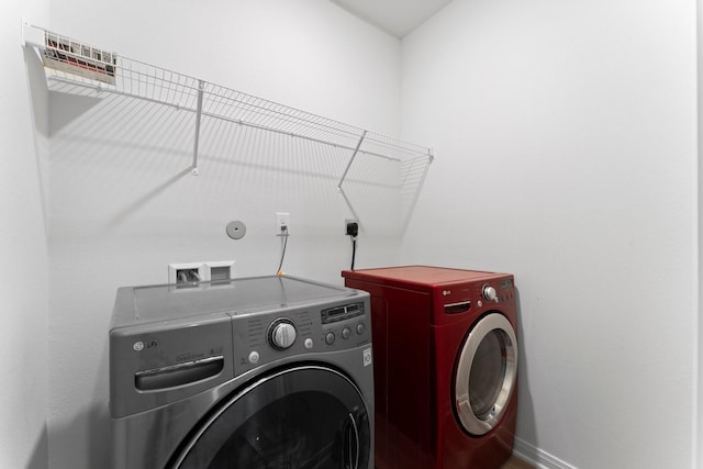 clothes washing area featuring washing machine and dryer