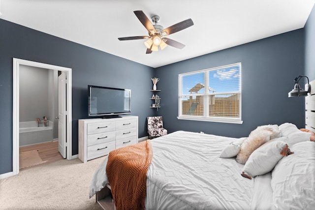 bedroom with ceiling fan, connected bathroom, and carpet