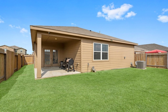 rear view of house featuring central AC, french doors, a lawn, and a patio