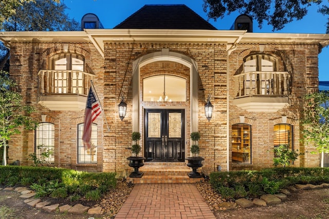 doorway to property with a balcony and french doors