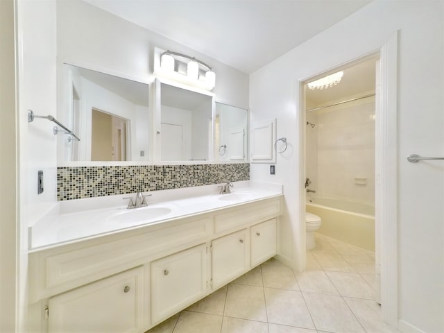 full bathroom with toilet, tasteful backsplash, shower / tub combination, tile patterned flooring, and vanity