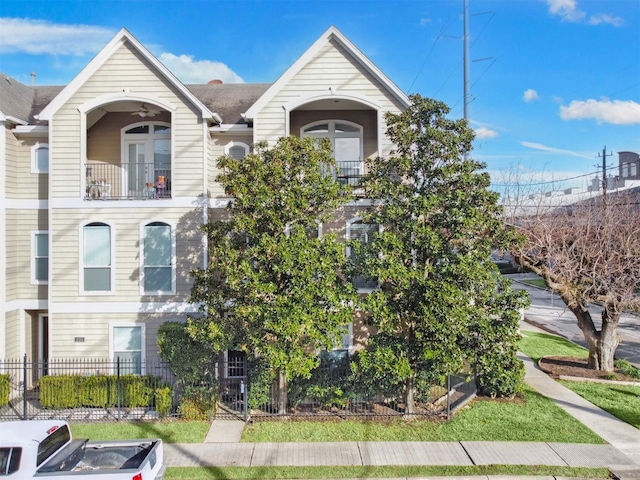 view of front of property with french doors and a balcony