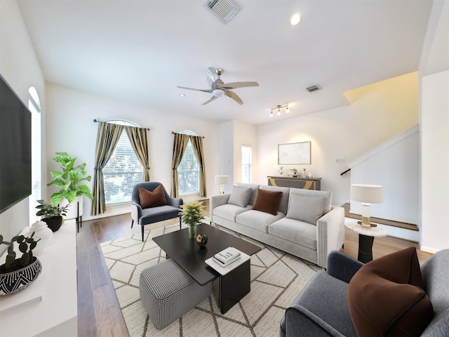 living room featuring ceiling fan and light wood-type flooring