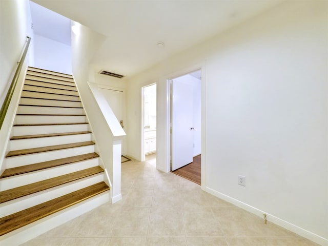 staircase with tile patterned flooring