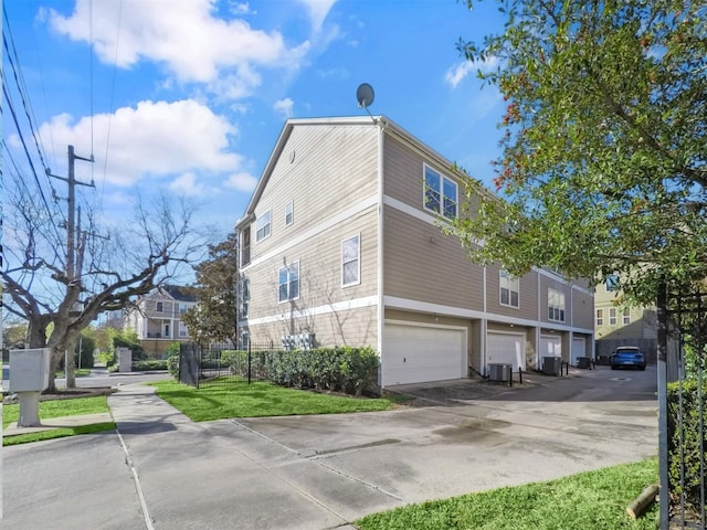 view of home's exterior with central AC and a garage