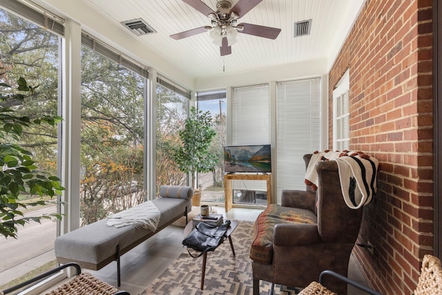 sunroom / solarium featuring ceiling fan