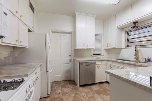 kitchen featuring light stone counters, sink, white cabinets, and stainless steel dishwasher