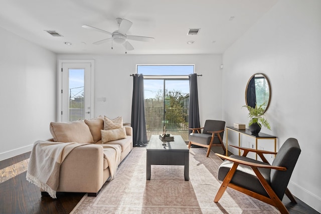 living room with ceiling fan and light hardwood / wood-style floors