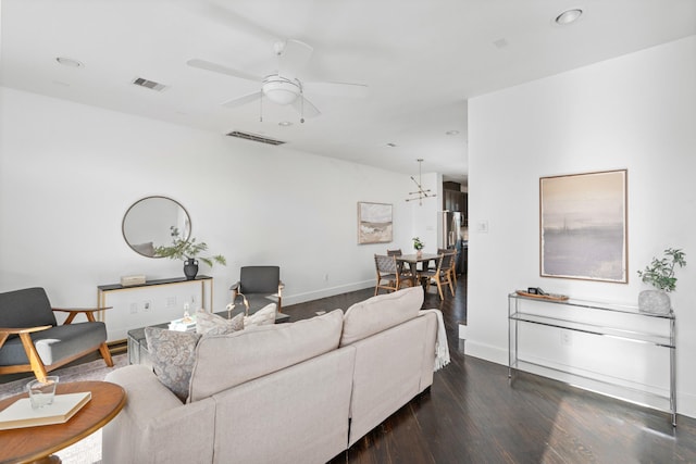 living room with ceiling fan and dark hardwood / wood-style floors