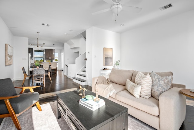 living room with ceiling fan and dark hardwood / wood-style floors