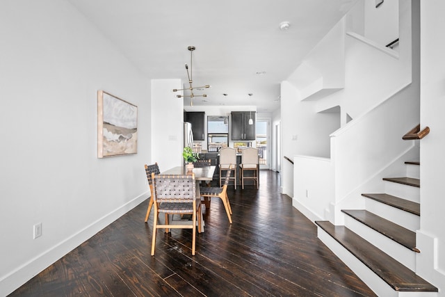 dining room with dark hardwood / wood-style floors and a notable chandelier