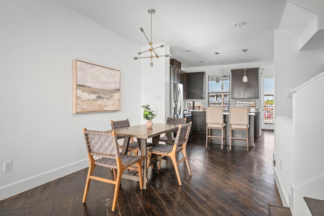 dining space featuring dark hardwood / wood-style floors and a notable chandelier