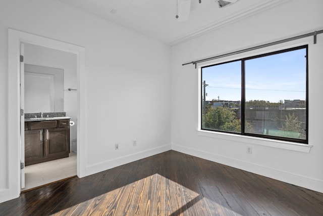 empty room with ceiling fan, hardwood / wood-style flooring, and sink