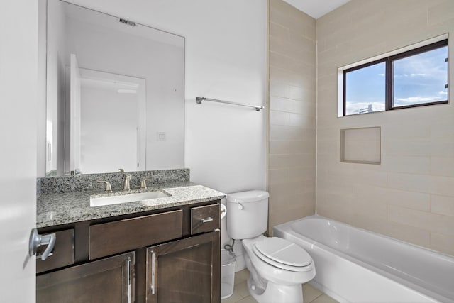 full bathroom with toilet, vanity, tiled shower / bath combo, and tile patterned flooring