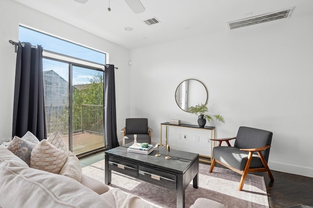 living room featuring ceiling fan and hardwood / wood-style flooring