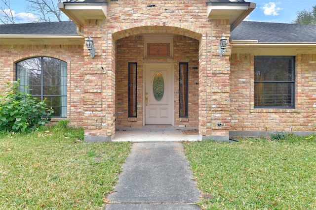 doorway to property with a lawn