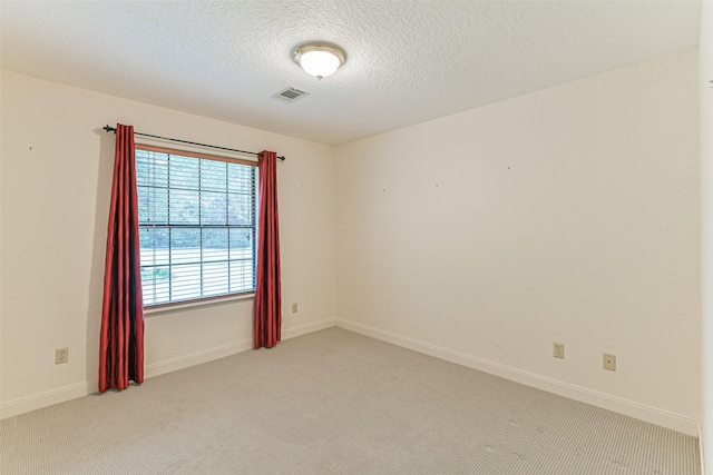 carpeted spare room featuring a textured ceiling