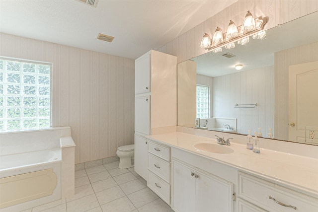 bathroom with tile patterned floors, a bathtub, vanity, and toilet